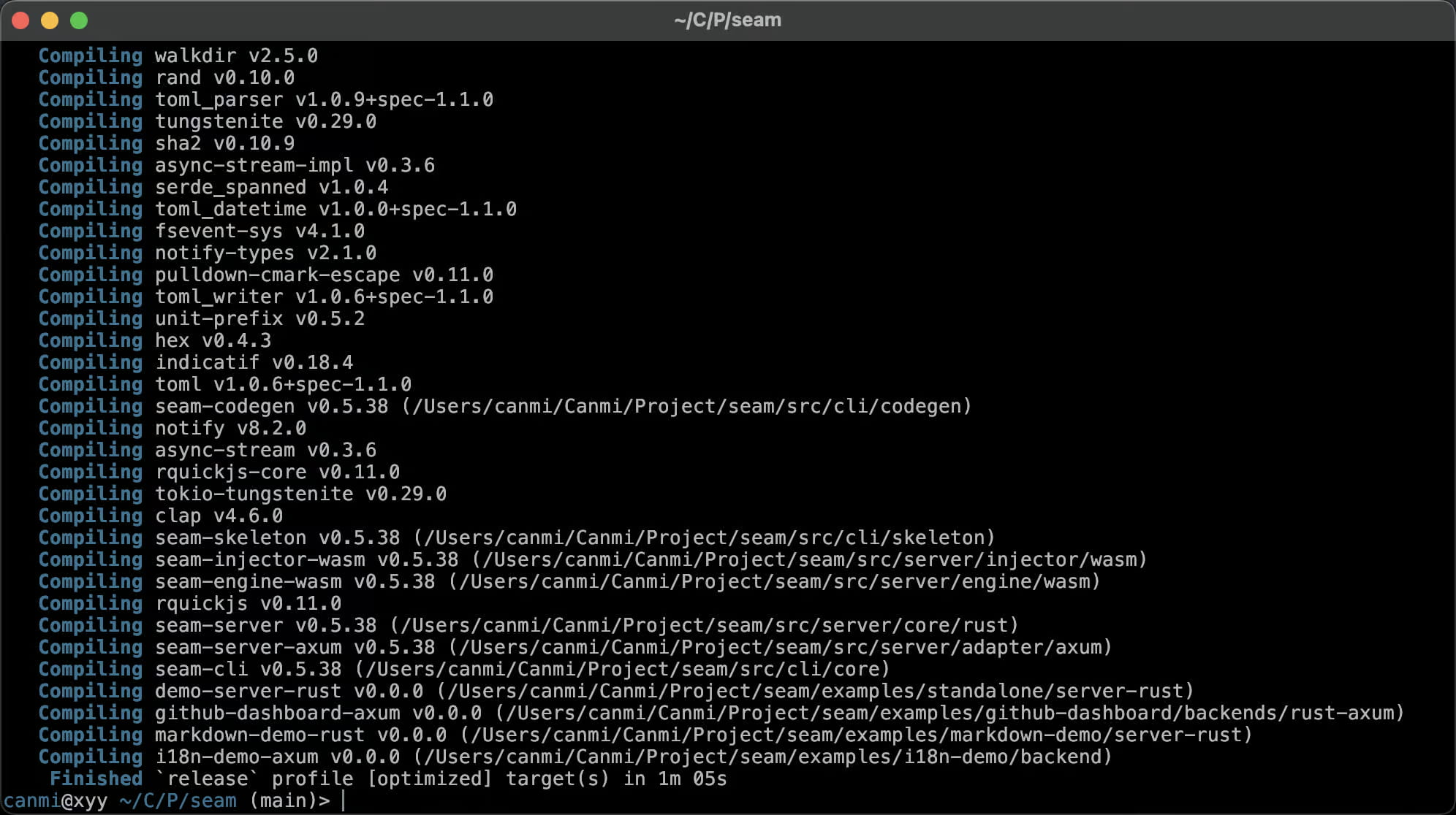 Dies ist ein Screenshot eines Terminalfensters mit dem Titel „~/C/P/seam“, das das Ende eines `cargo build --release`-Durchlaufs für das Projekt „seam“ zeigt. Die Bildlaufleiste listet Dutzende von Abhängigkeits‑Crates auf, die nacheinander kompiliert werden – walkdir, rand, tungstenite, sha2, toml, notify, rquickjs, clap und weitere – gefolgt von den eigenen Arbeitsbereichs‑Mitgliedern des Projekts wie seam-codegen, seam-skeleton, seam-injector-wasm, seam-engine-wasm, seam-server, seam-server-axum, seam-cli und mehreren Beispiel‑Backends (demo-server-rust, github-dashboard-axum, markdown-demo-rust, i18n-demo-axum). Die letzten Zeilen bestätigen den Erfolg: „Finished `release` profile [optimized] target(s) in 1m 05s“, gefolgt von einer Leerlauf‑Shell‑Eingabeaufforderung `canmi@xyy ~/C/P/seam (main)>`. Es ist ein Beweis für einen sauberen, vollständigen Release‑Build eines mehr‑Crate‑Rust‑Monorepos mit WASM‑ und Axum‑Server‑Komponenten.
